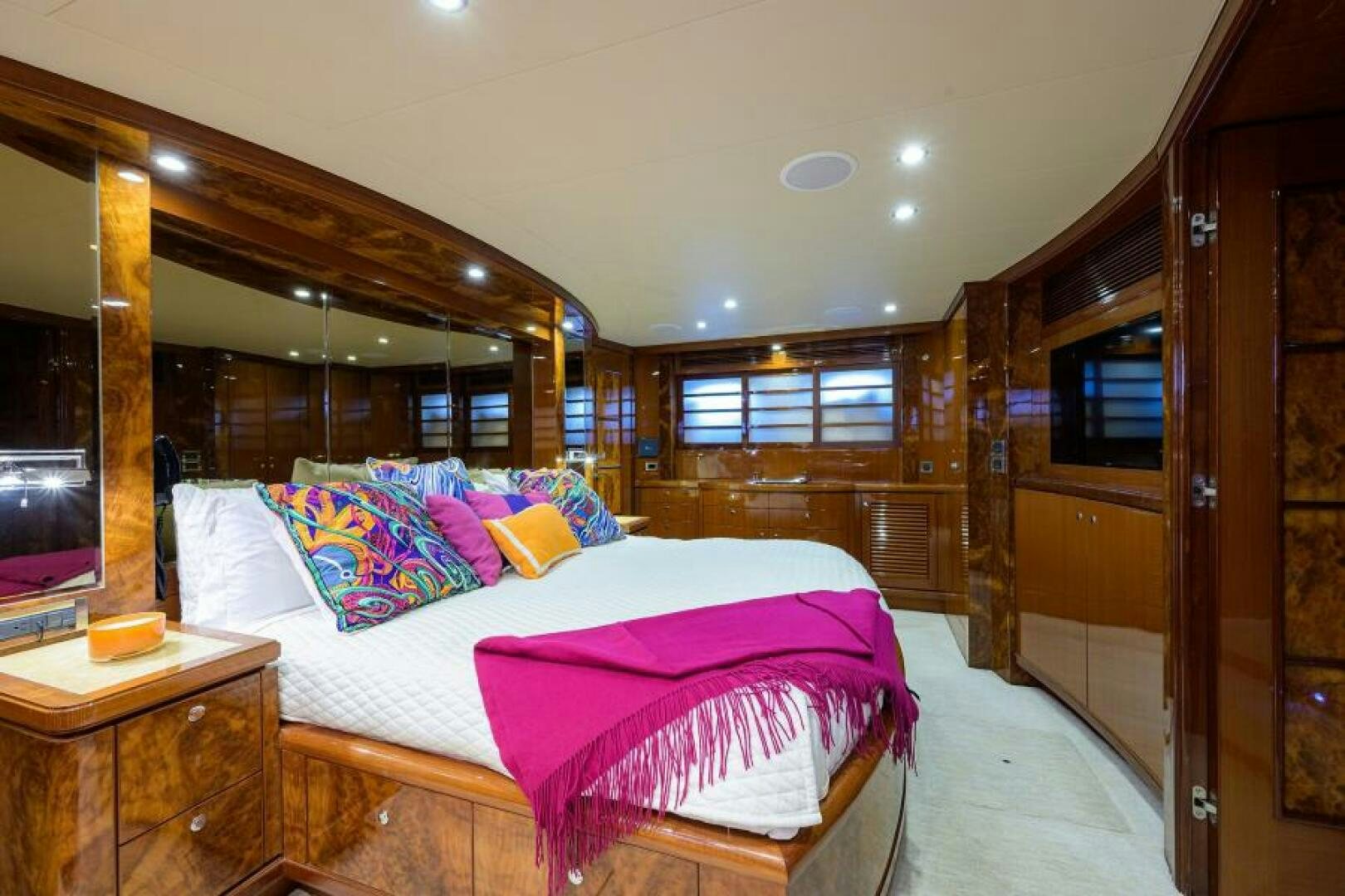 a bedroom with a bed and a wood door aboard BARNSTAR Yacht for Sale
