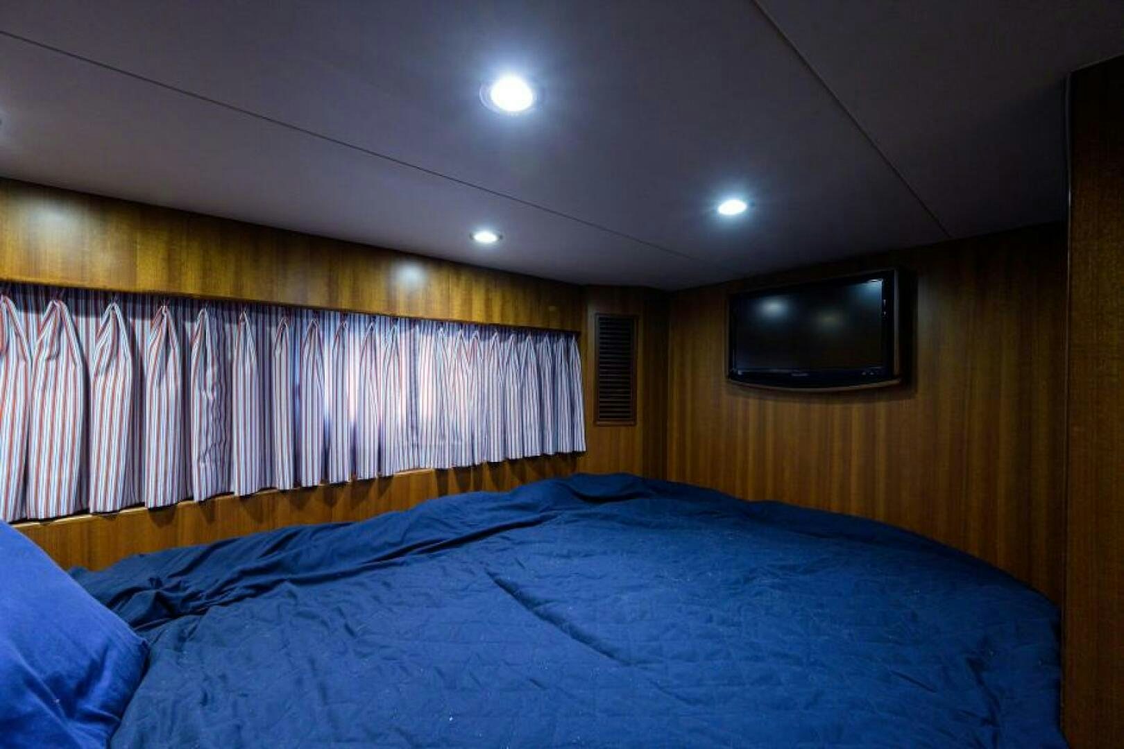 a bed with blue sheets aboard BARNSTAR Yacht for Sale