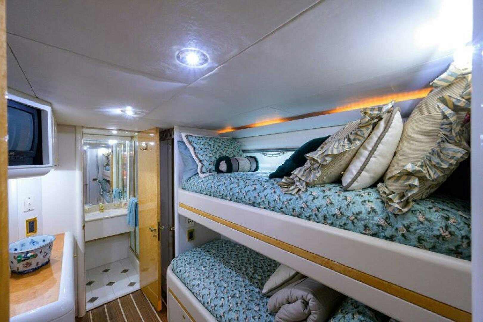 a bedroom with a bed and a television aboard 80' LAZZARA Yacht for Sale