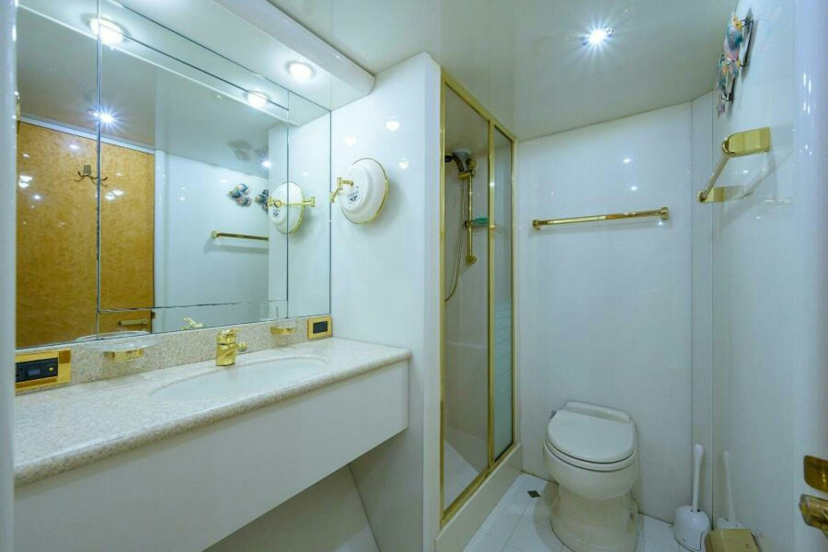 a bathroom with a glass shower aboard 80' LAZZARA Yacht for Sale