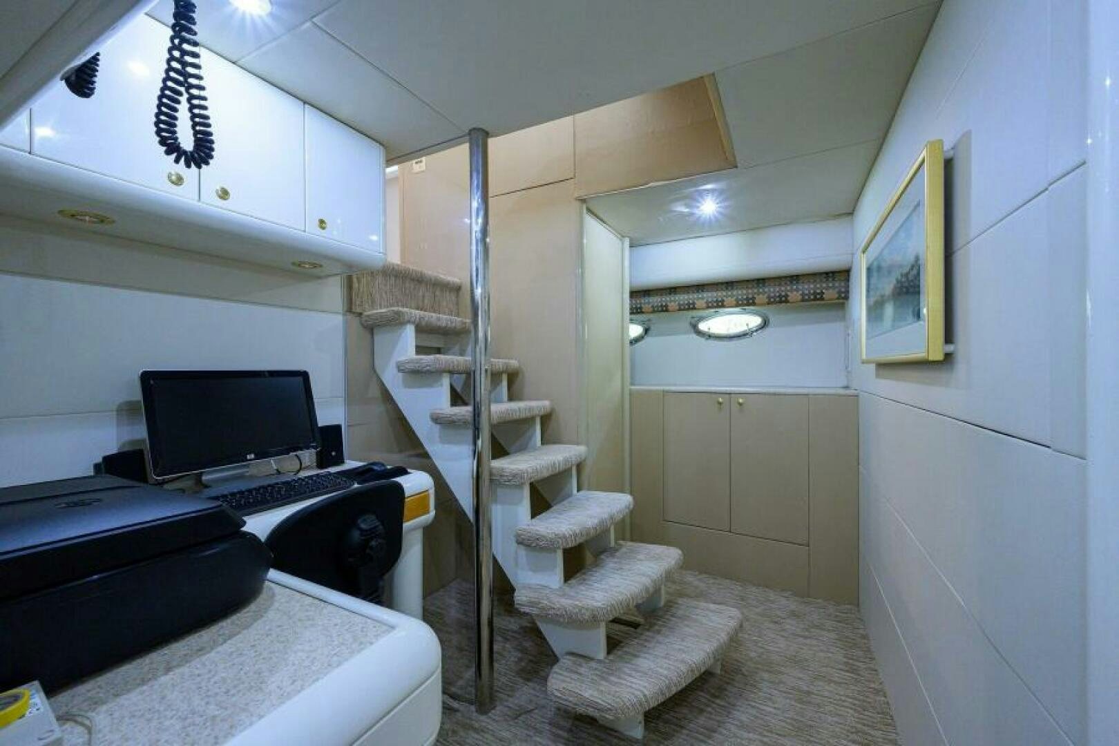 a small white room with a desk and a computer aboard 80' LAZZARA Yacht for Sale