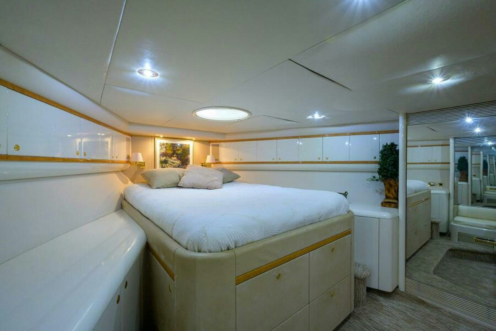 a bedroom with a bed and a closet aboard 80' LAZZARA Yacht for Sale