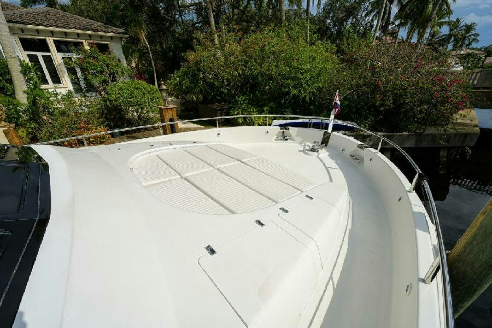 a white boat with a flag on it aboard 80' LAZZARA Yacht for Sale