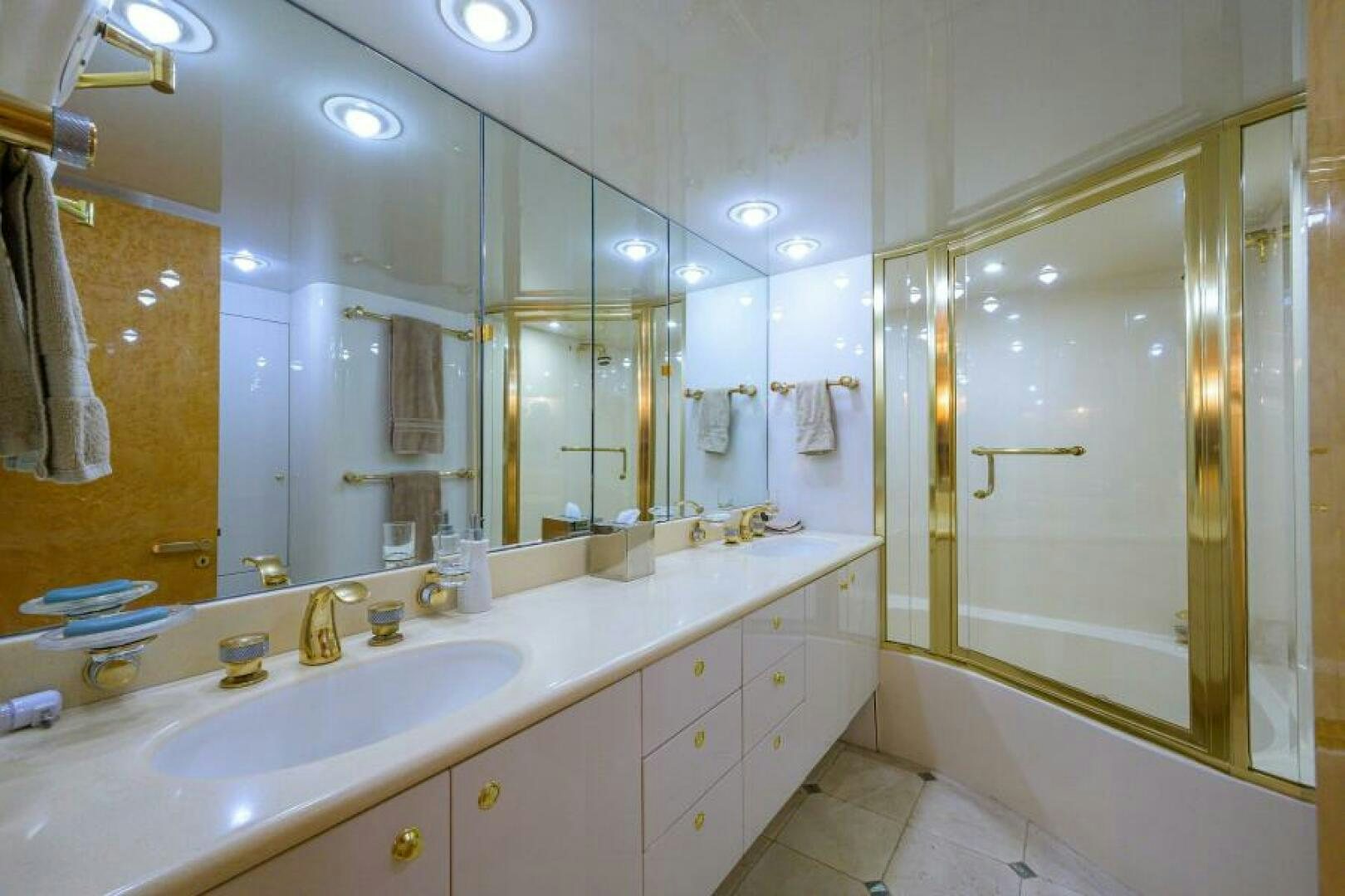 a bathroom with a large mirror aboard 80' LAZZARA Yacht for Sale