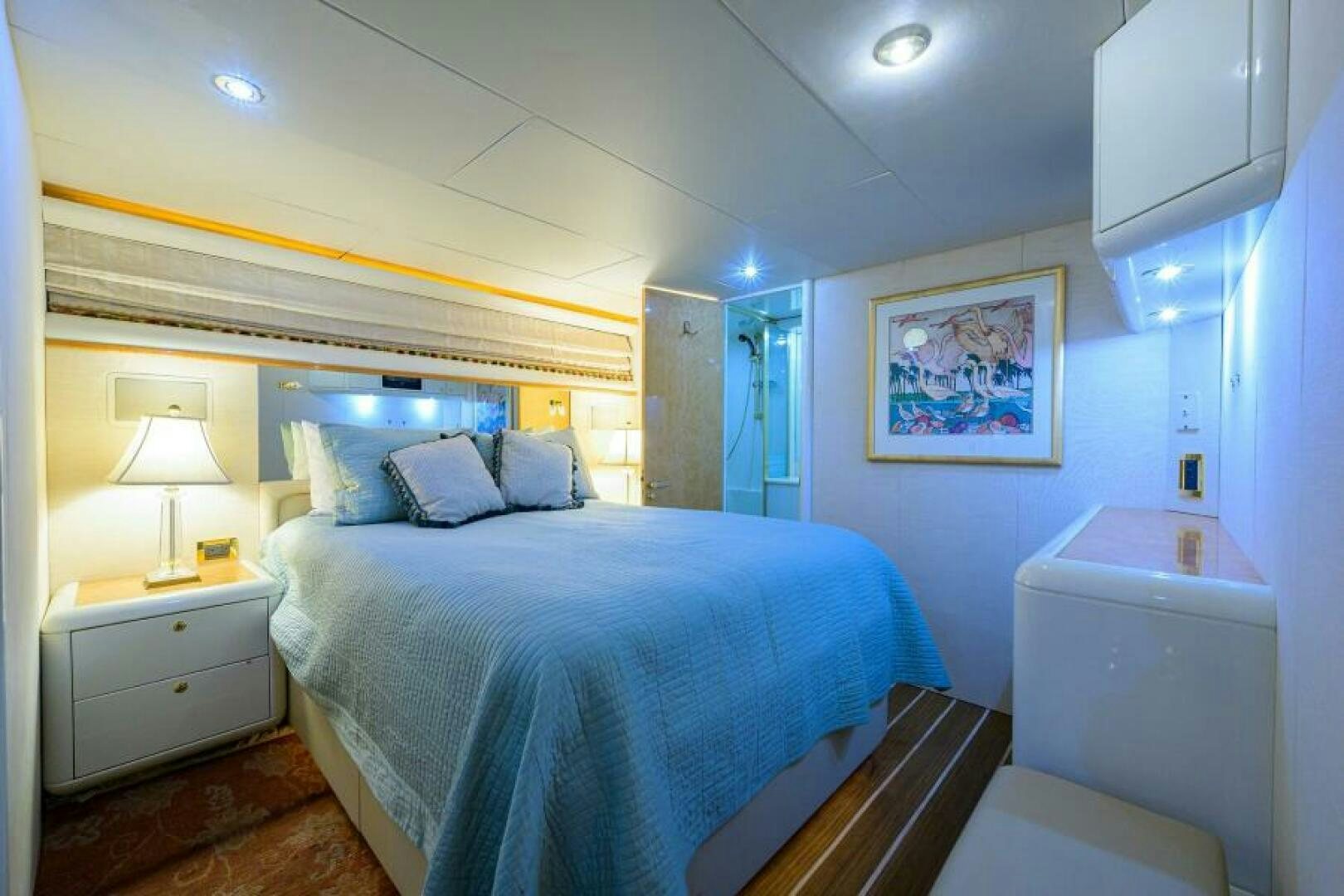 a bedroom with a bed and a desk aboard 80' LAZZARA Yacht for Sale