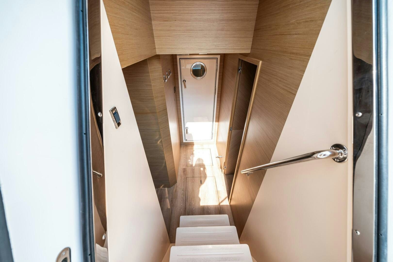 a wooden staircase with a metal railing aboard AFTER MIDNIGHT Yacht for Sale