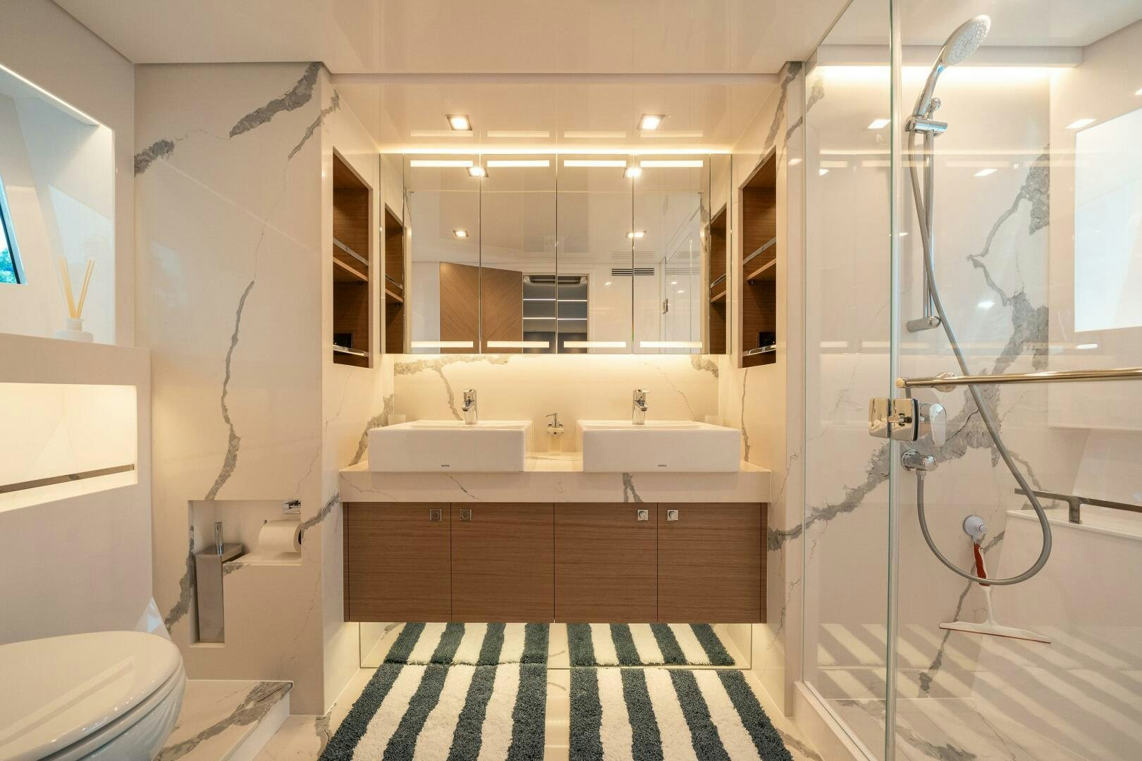 a bathroom with a shower and sink aboard AFTER MIDNIGHT Yacht for Sale