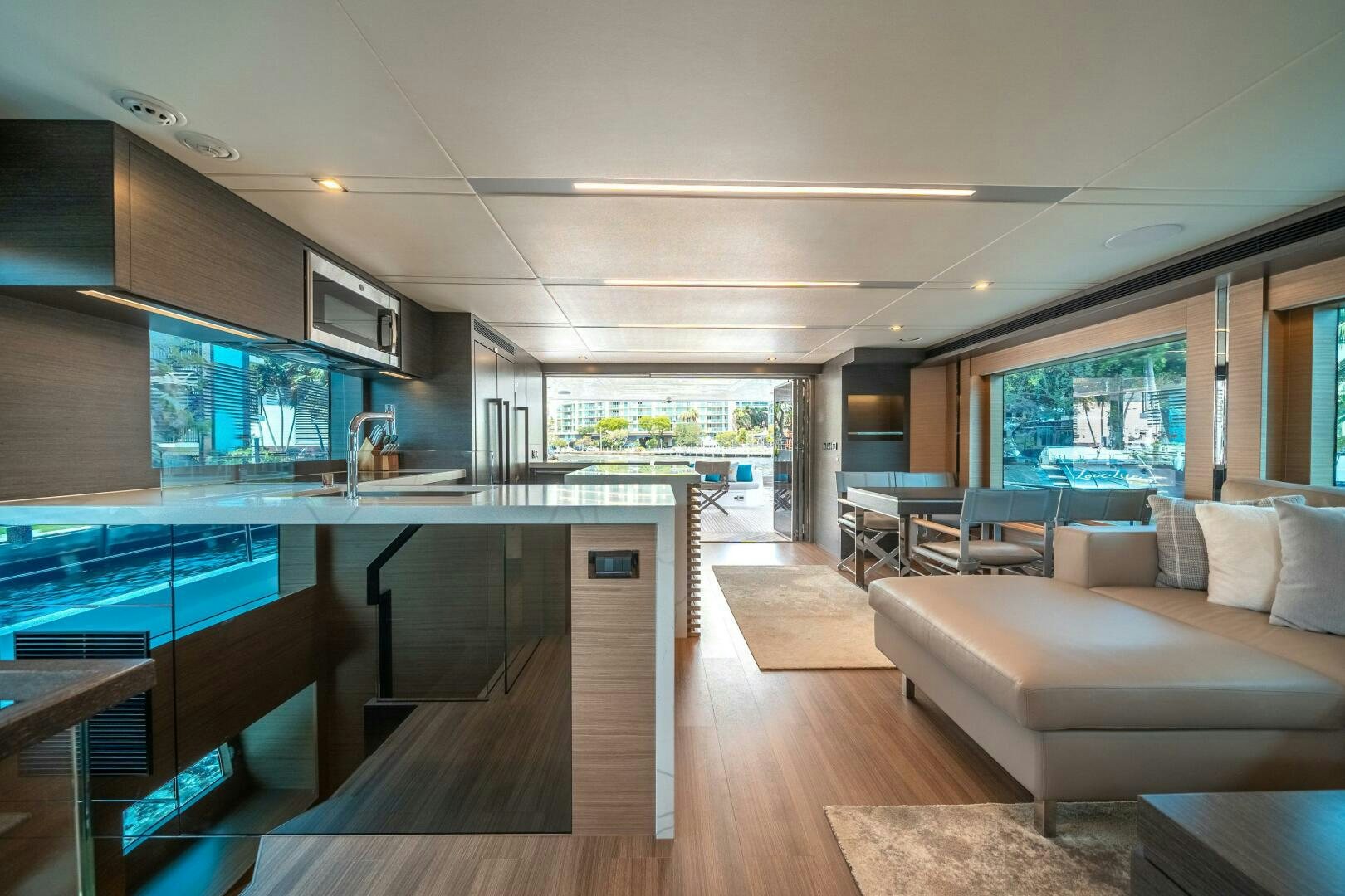 a large living room with a large kitchen and a large window aboard AFTER MIDNIGHT Yacht for Sale