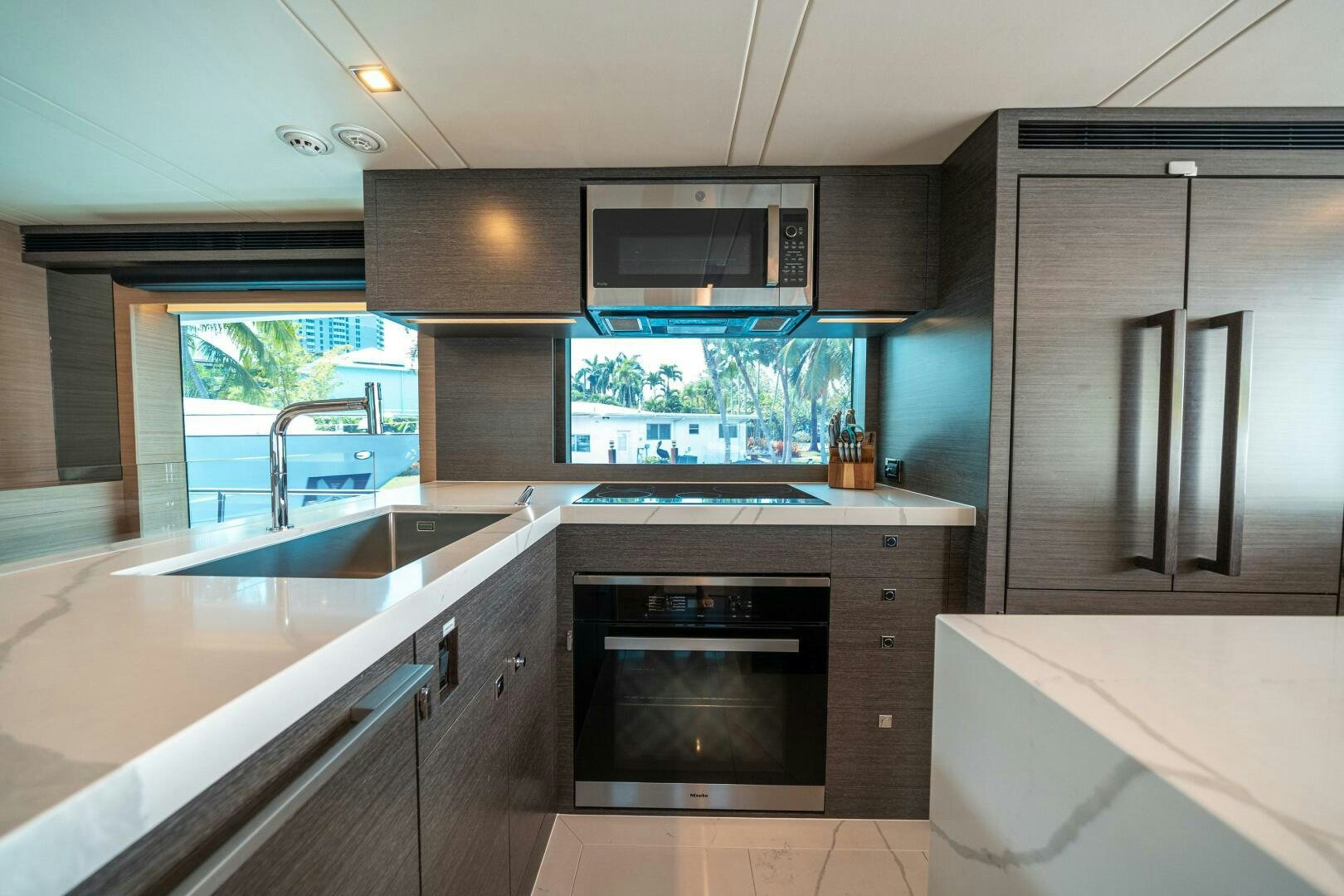 a kitchen with a sink and stove aboard AFTER MIDNIGHT Yacht for Sale