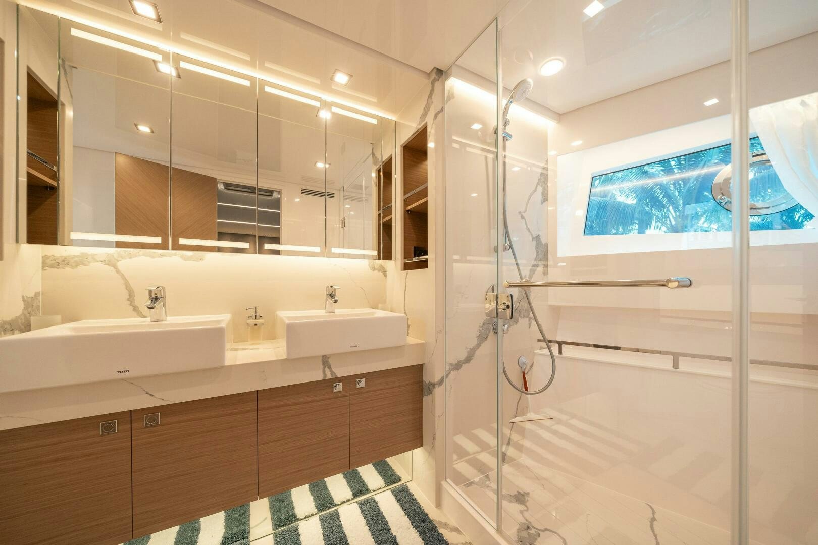 a bathroom with a shower unit and sink aboard AFTER MIDNIGHT Yacht for Sale