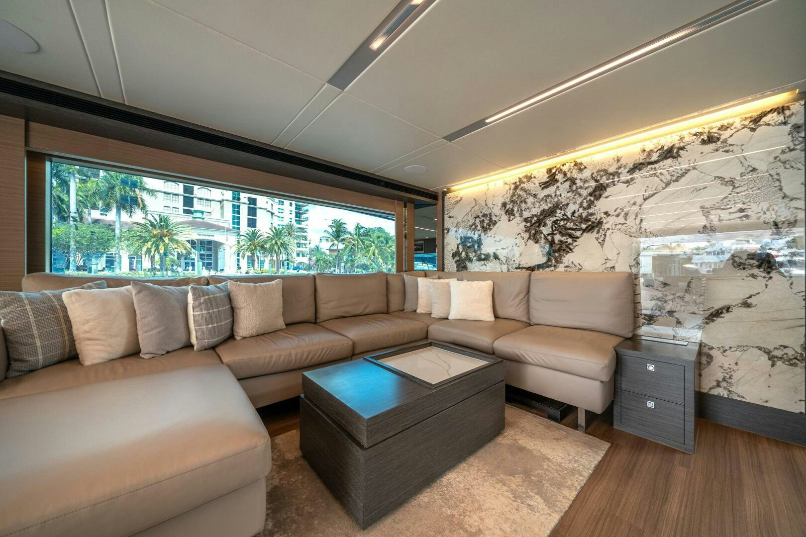 a living room with a large window aboard AFTER MIDNIGHT Yacht for Sale