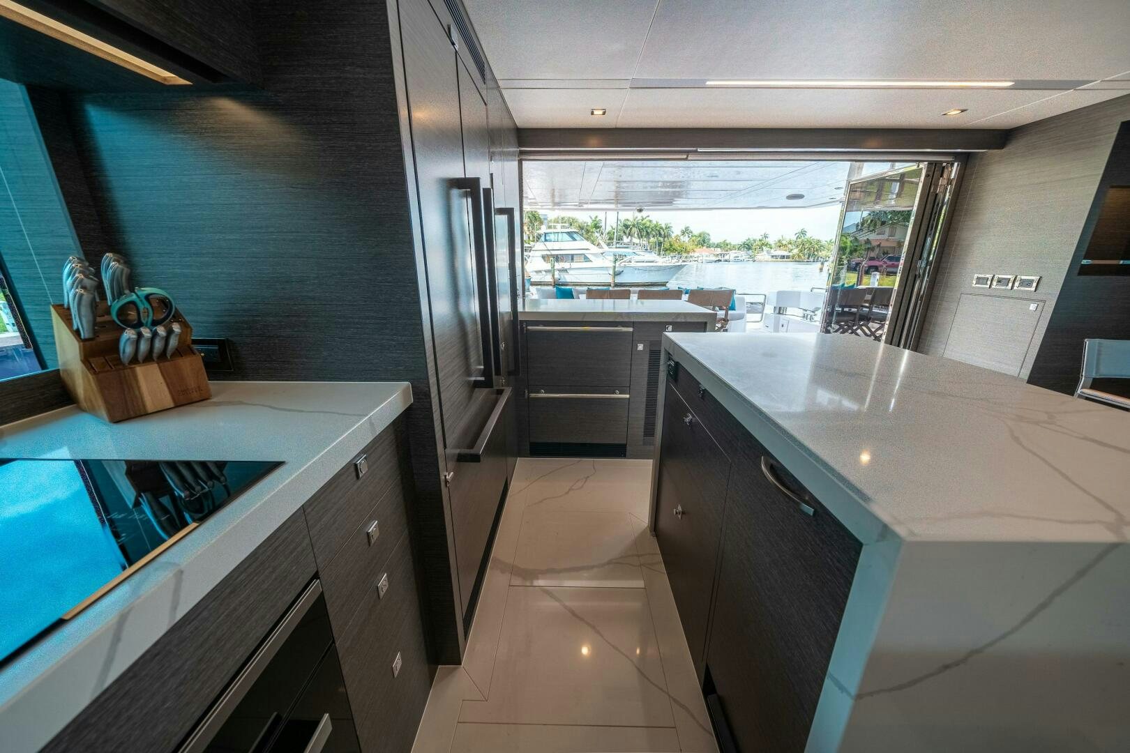 a kitchen with a large window aboard AFTER MIDNIGHT Yacht for Sale