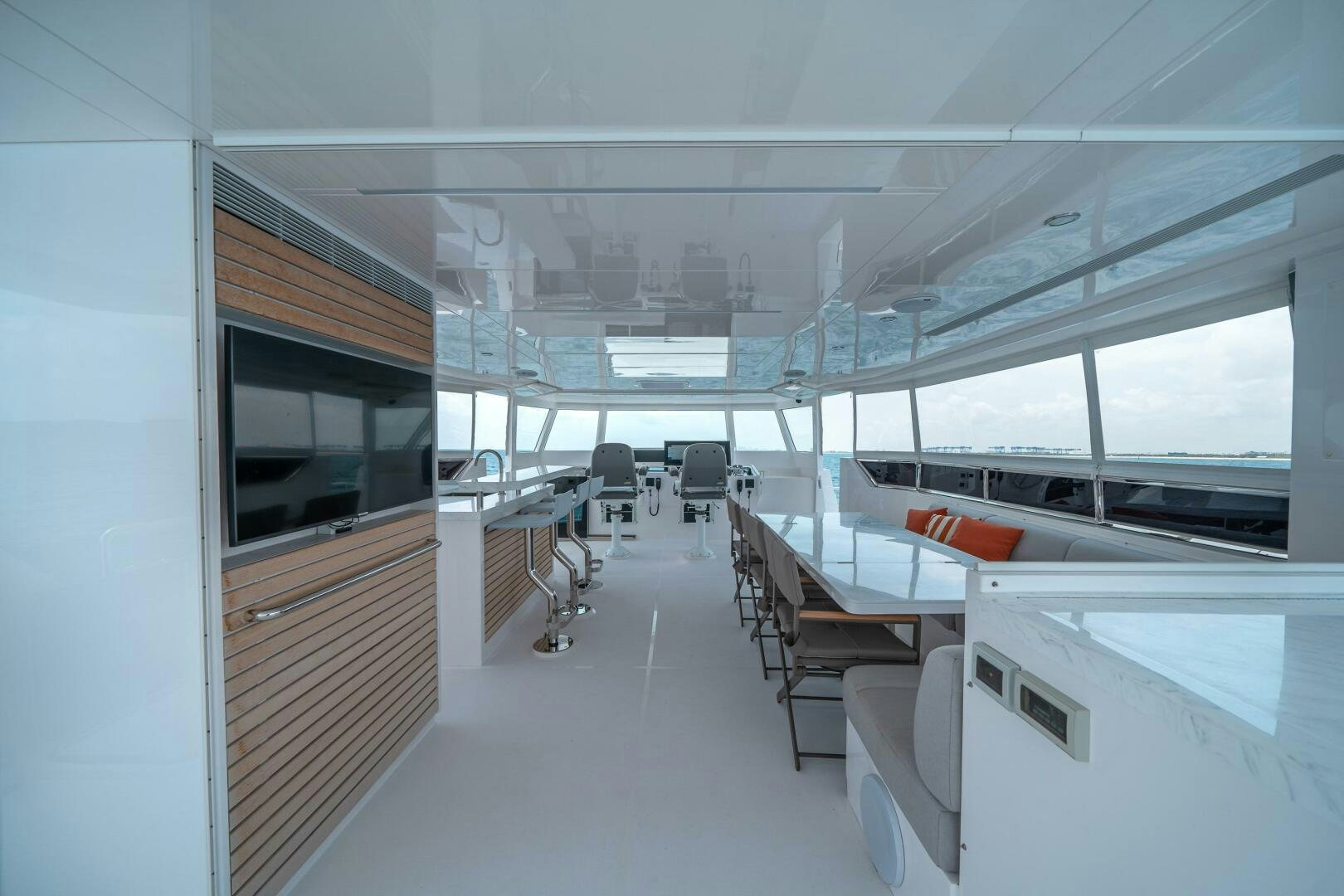 a room with tables and chairs aboard AFTER MIDNIGHT Yacht for Sale