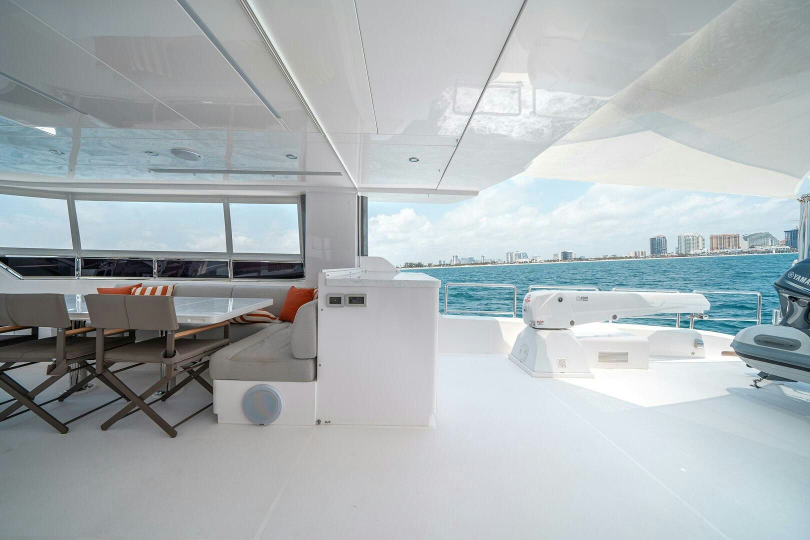 a room with a couch and a table and chairs aboard AFTER MIDNIGHT Yacht for Sale