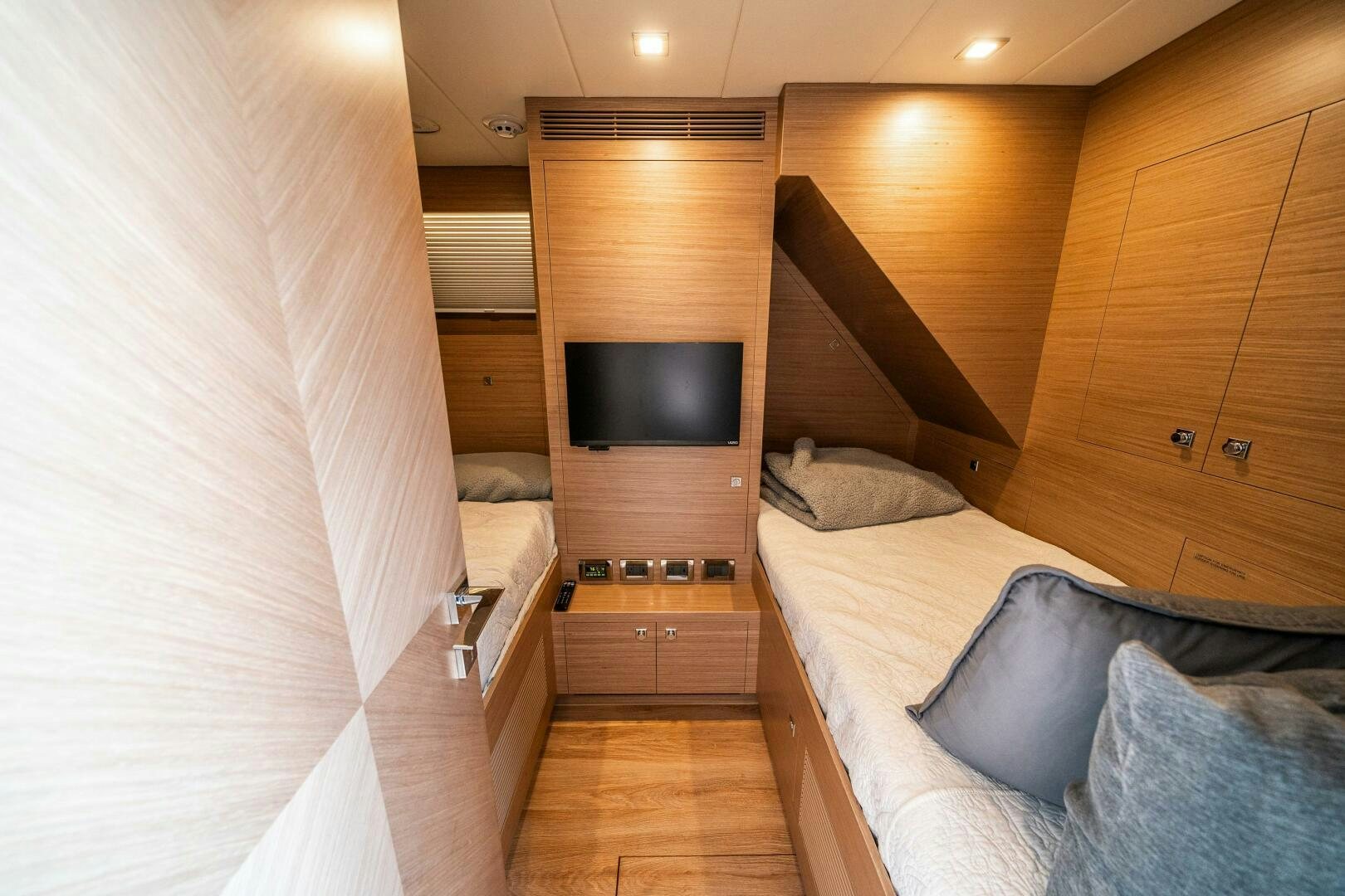 a room with a bed and a television aboard AFTER MIDNIGHT Yacht for Sale