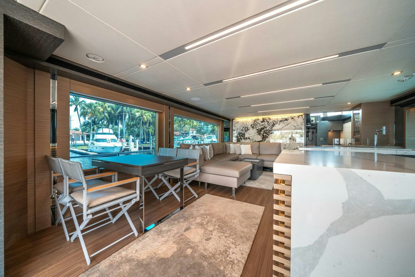 a living room with a pool table and chairs aboard AFTER MIDNIGHT Yacht for Sale
