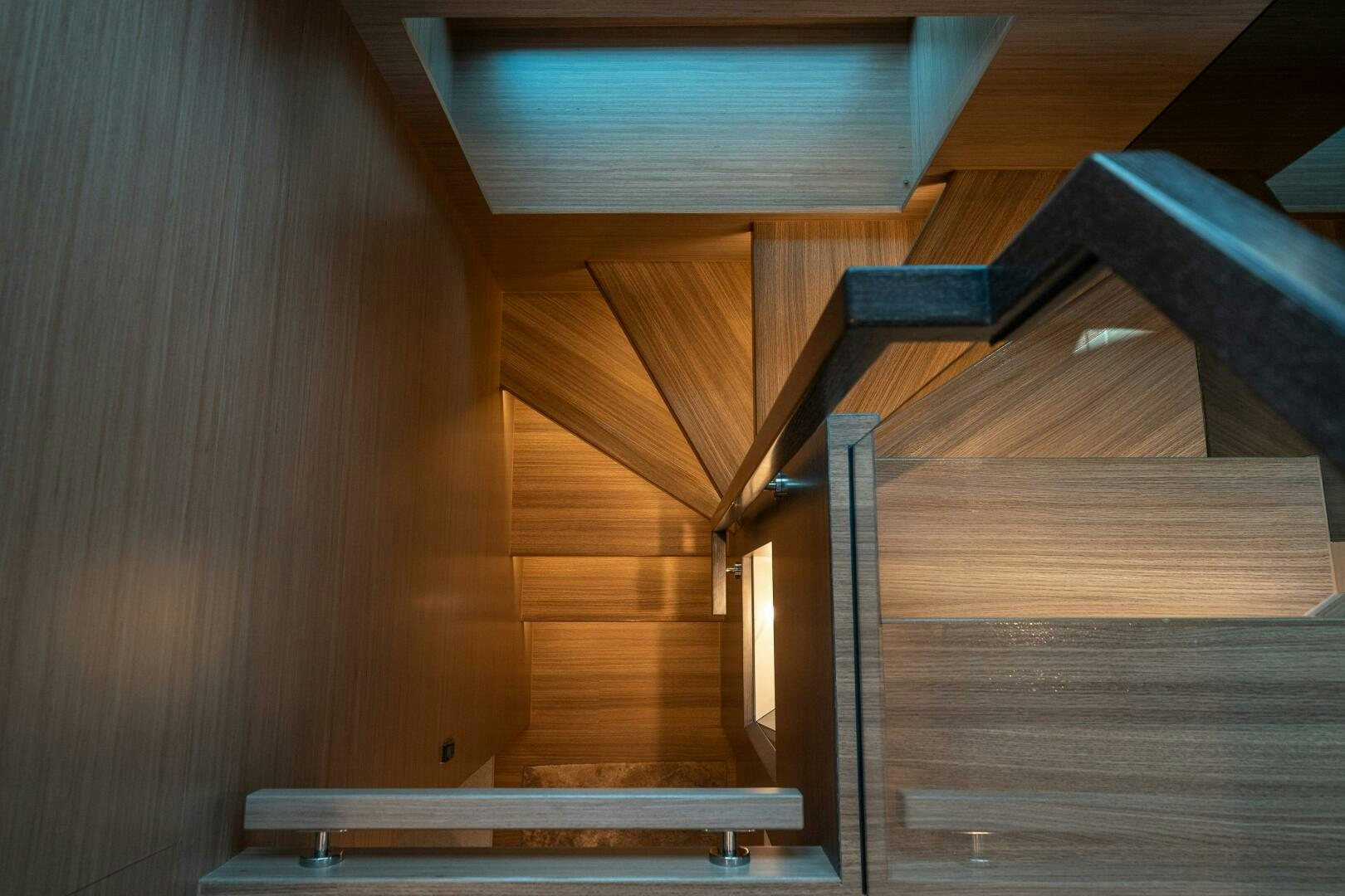 a wooden staircase with a wood railing aboard AFTER MIDNIGHT Yacht for Sale