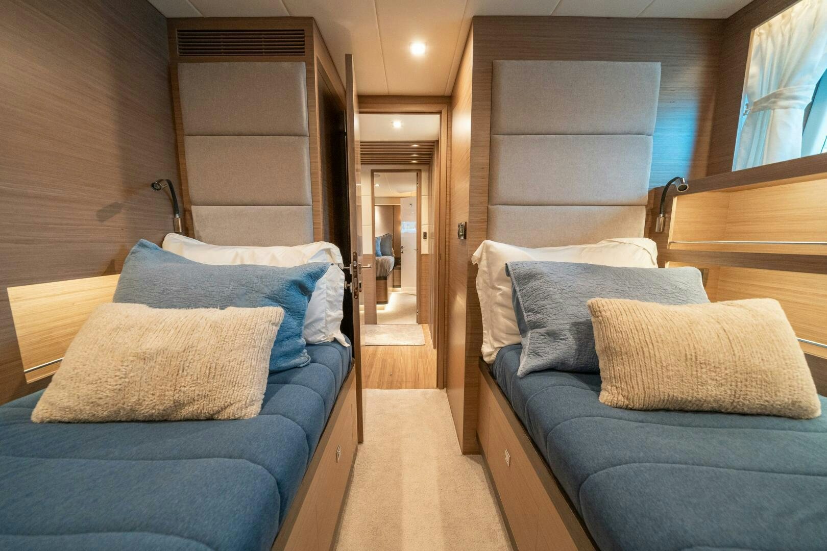 a room with a bed and a chair aboard AFTER MIDNIGHT Yacht for Sale