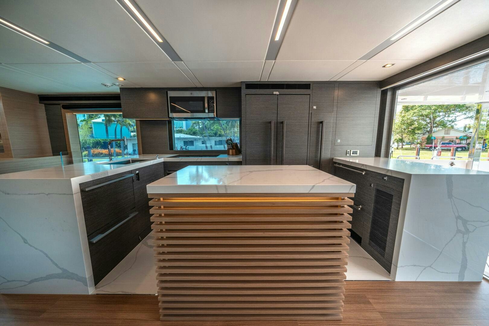 a kitchen with a large island aboard AFTER MIDNIGHT Yacht for Sale