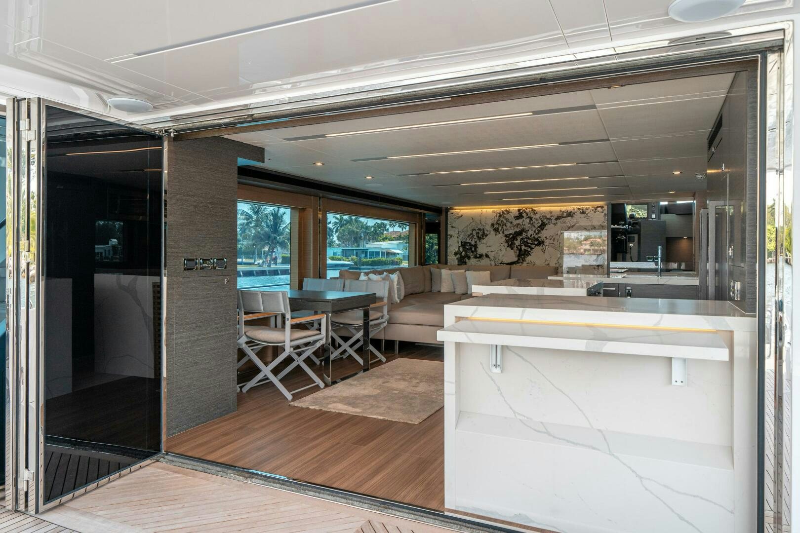 a room with a large window and a table and chairs aboard AFTER MIDNIGHT Yacht for Sale