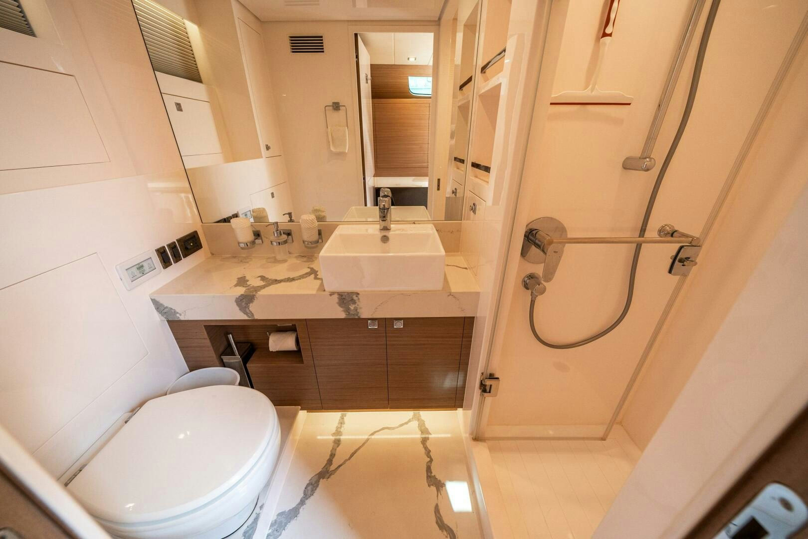 a bathroom with a toilet sink and a mirror aboard AFTER MIDNIGHT Yacht for Sale