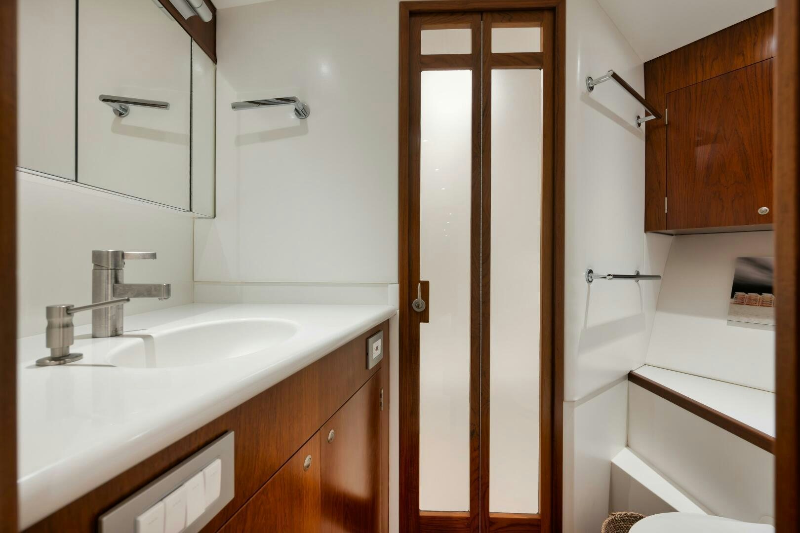 a bathroom with a sink and a door aboard BOXER Yacht for Sale