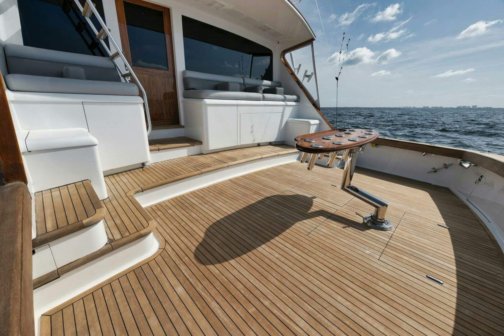 a deck with a table and chairs on it aboard BOXER Yacht for Sale