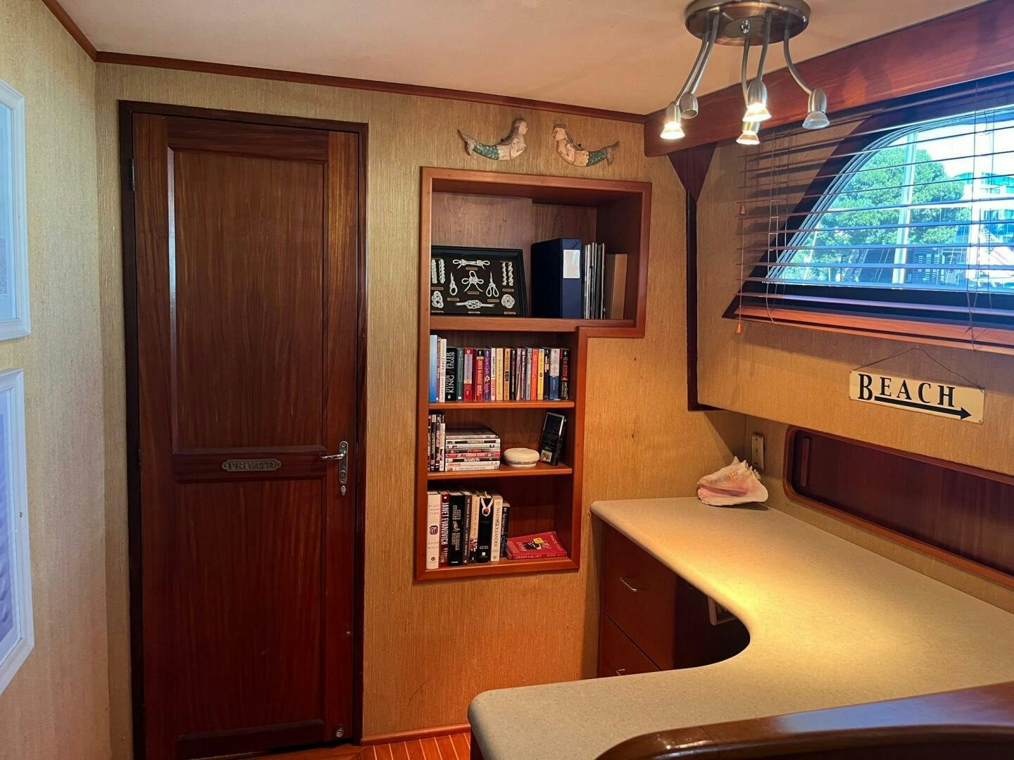 a room with a desk and a book shelf aboard LADY T Yacht for Sale