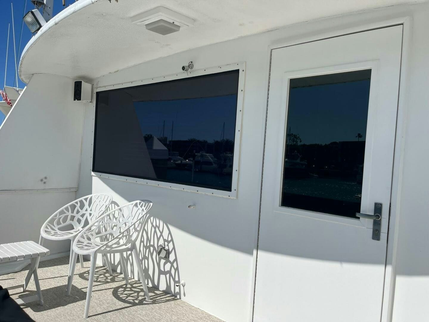 a white room with a window and a chair aboard LADY T Yacht for Sale