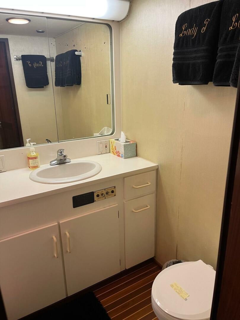 a bathroom with a mirror and a sink aboard LADY T Yacht for Sale