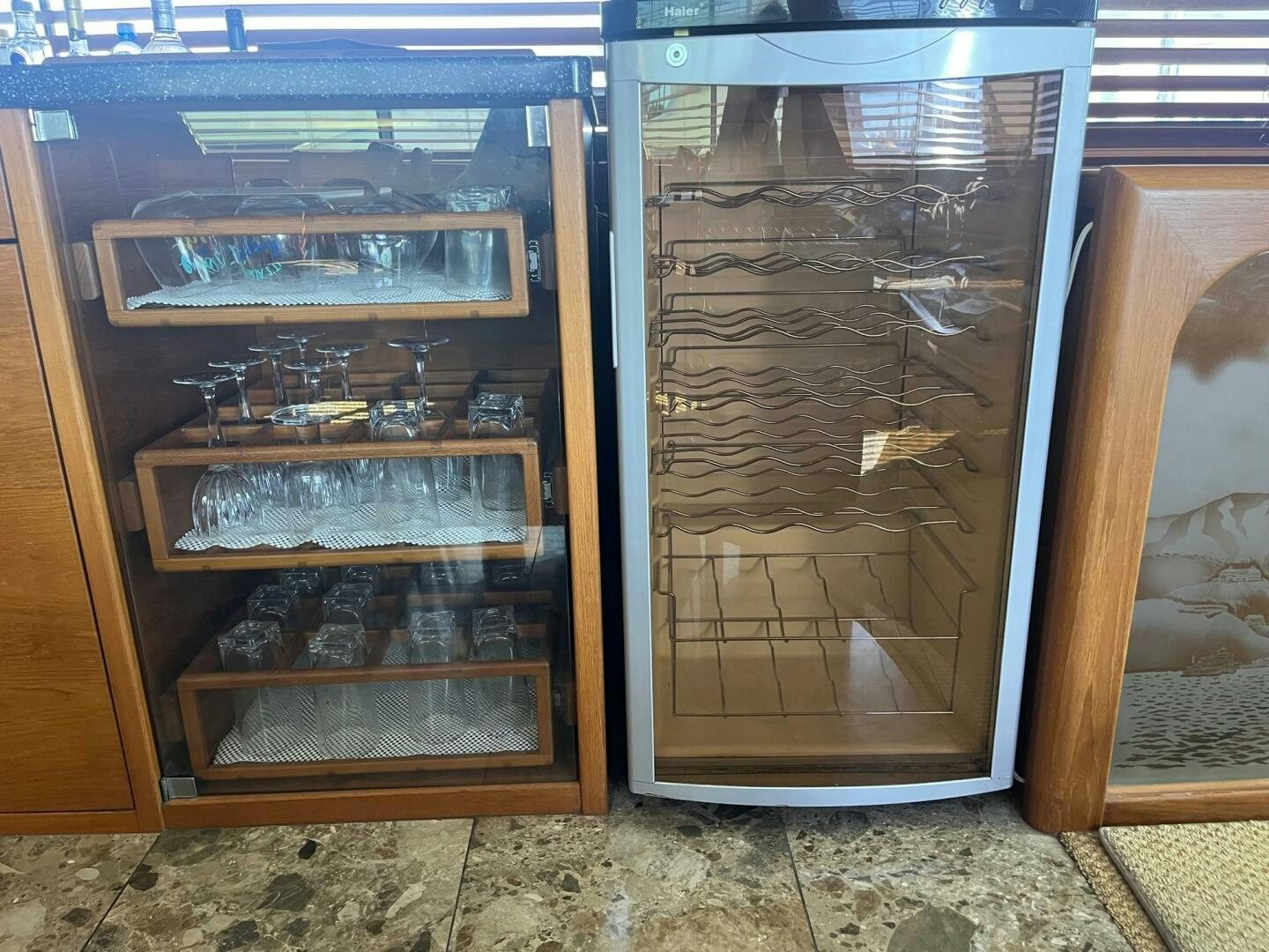 a glass cabinet with a door open aboard LADY T Yacht for Sale