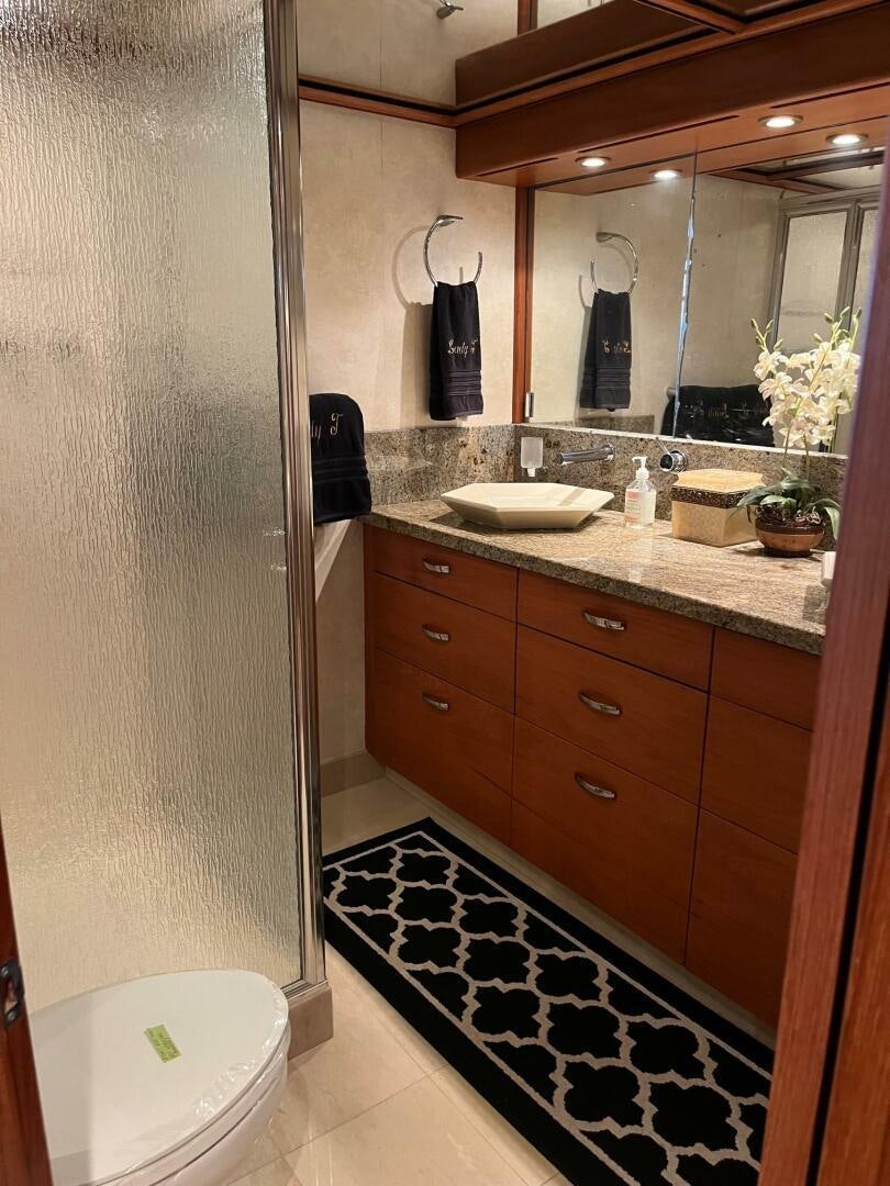 a bathroom with a sink and a mirror aboard LADY T Yacht for Sale