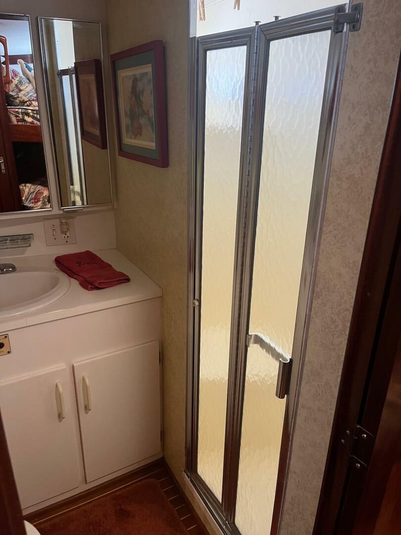a bathroom with a sink and a mirror aboard LADY T Yacht for Sale