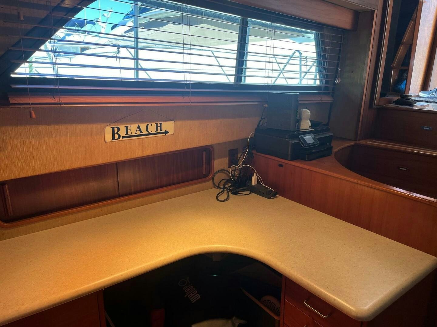 a desk with a computer and a window aboard LADY T Yacht for Sale