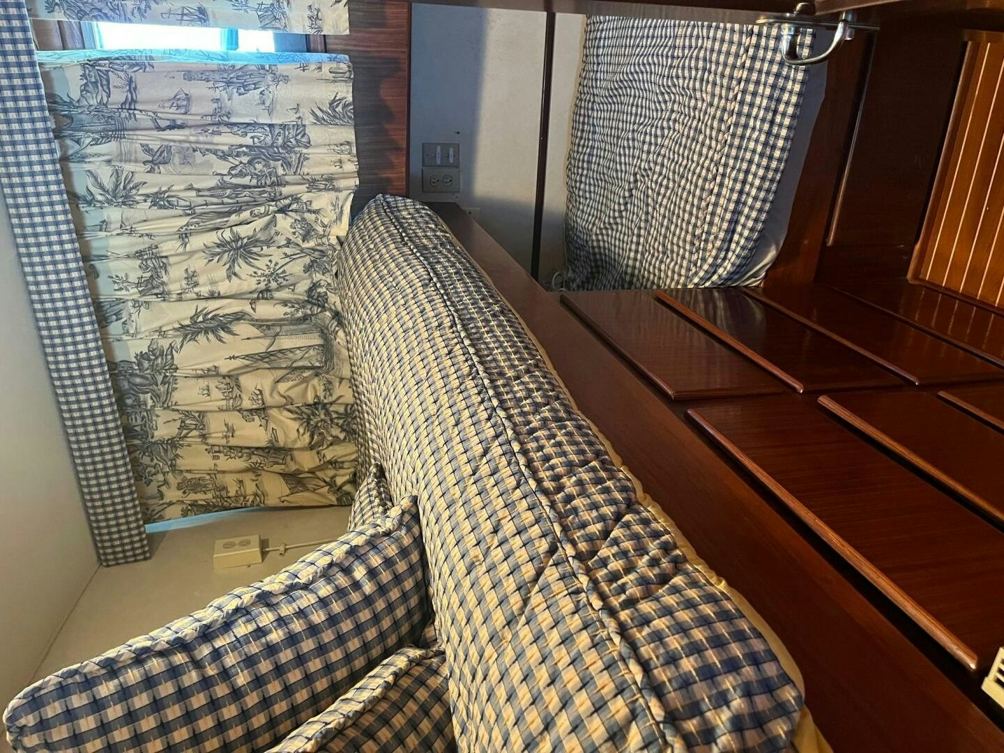a bed with a patterned sheet aboard LADY T Yacht for Sale