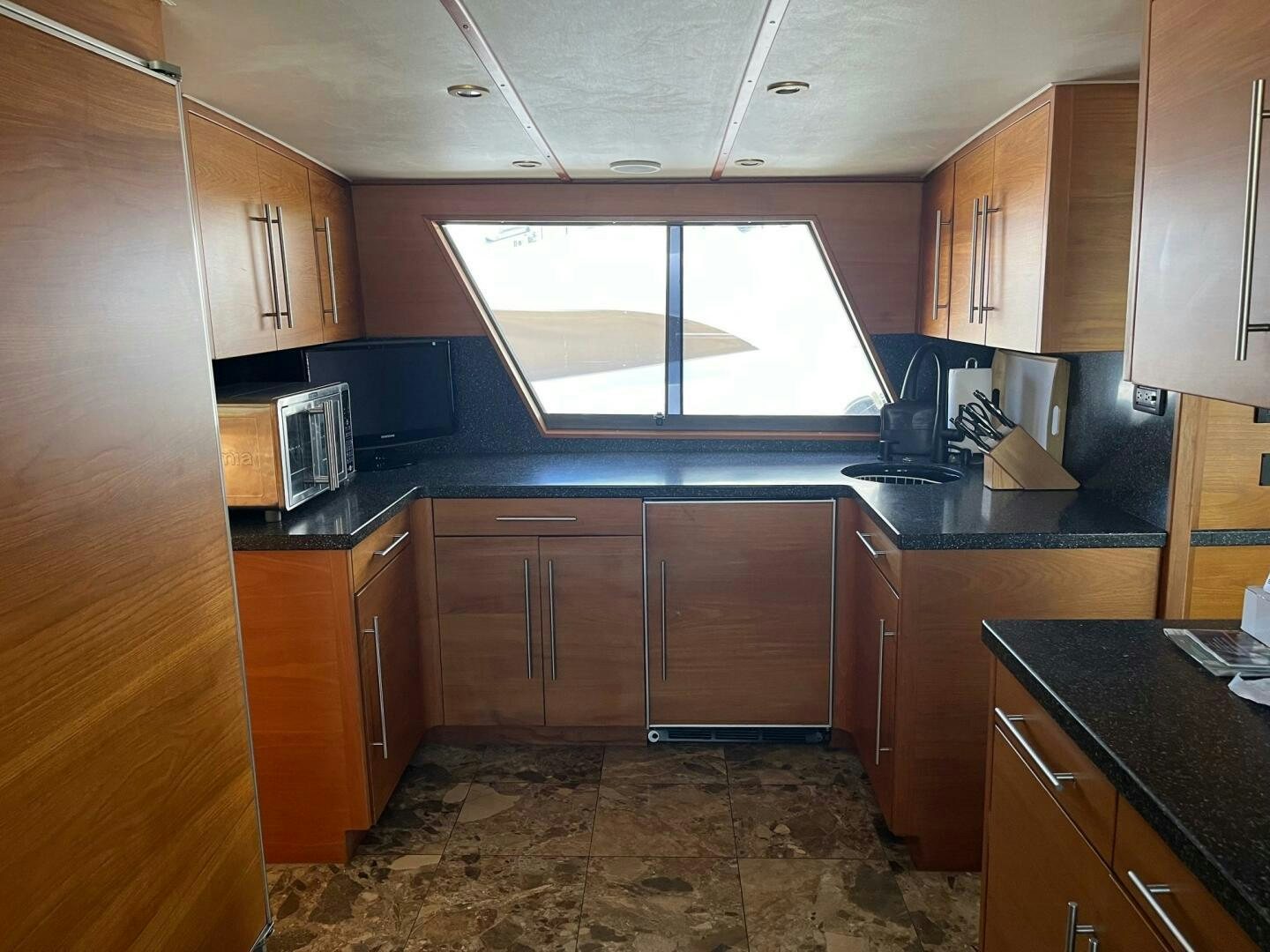 a kitchen with wooden cabinets aboard LADY T Yacht for Sale