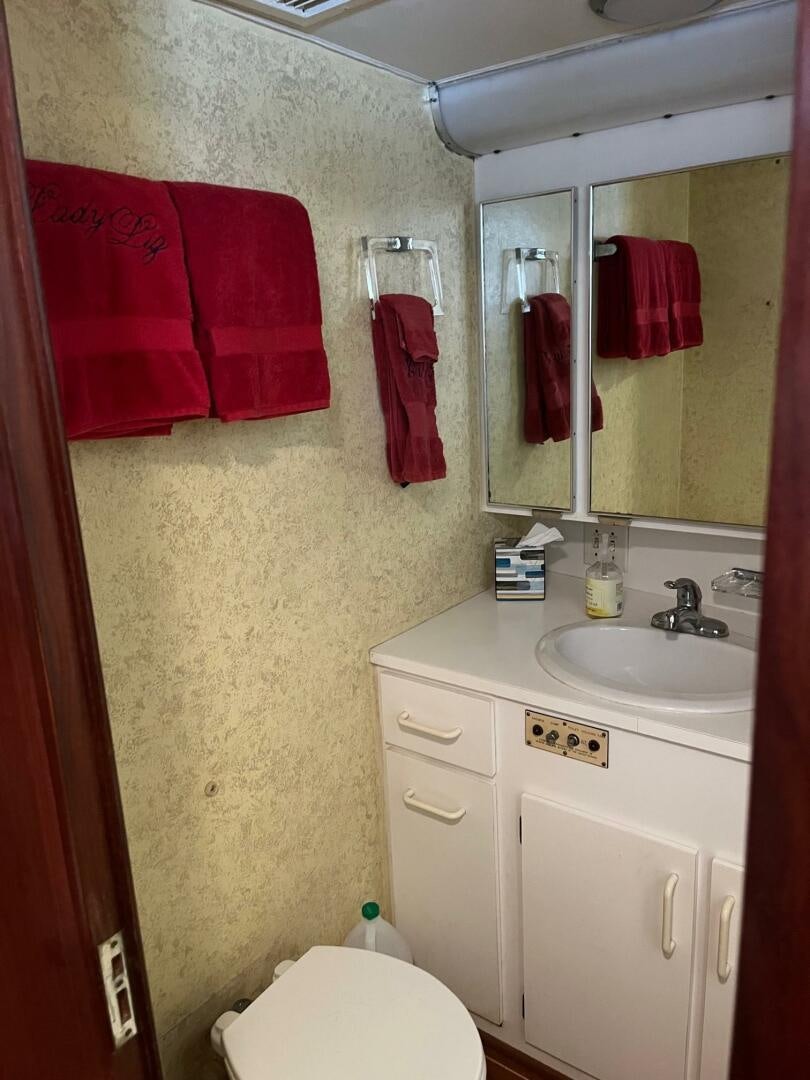 a bathroom with red towels aboard LADY T Yacht for Sale