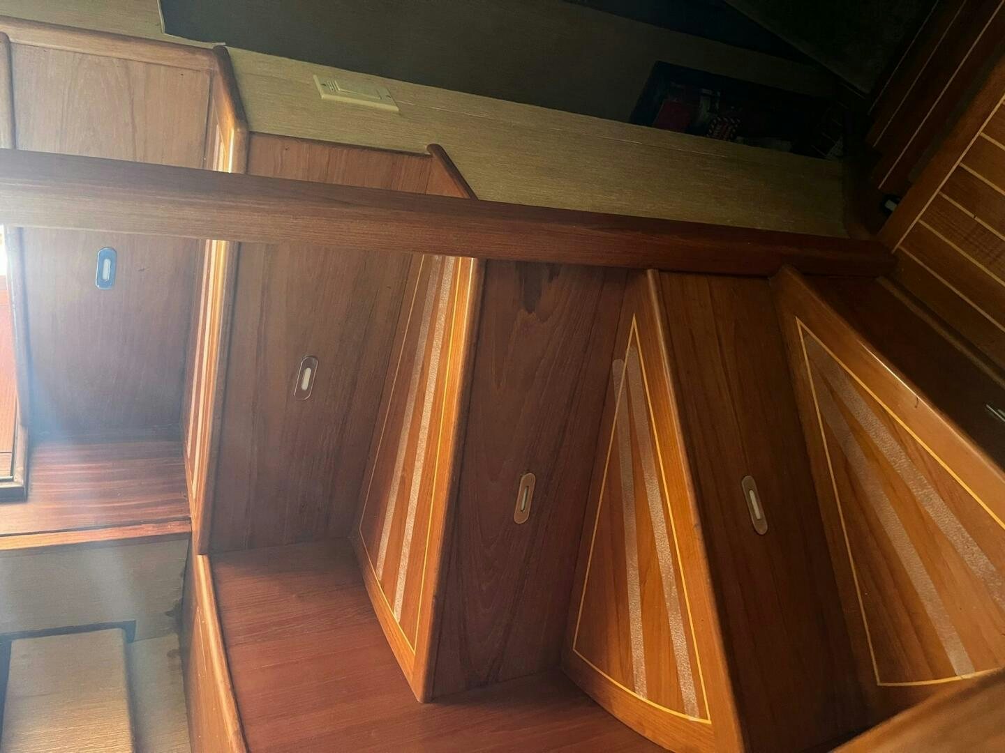 a wooden cabinet with wooden doors aboard LADY T Yacht for Sale