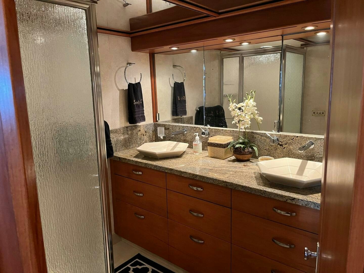 a bathroom with a large mirror aboard LADY T Yacht for Sale