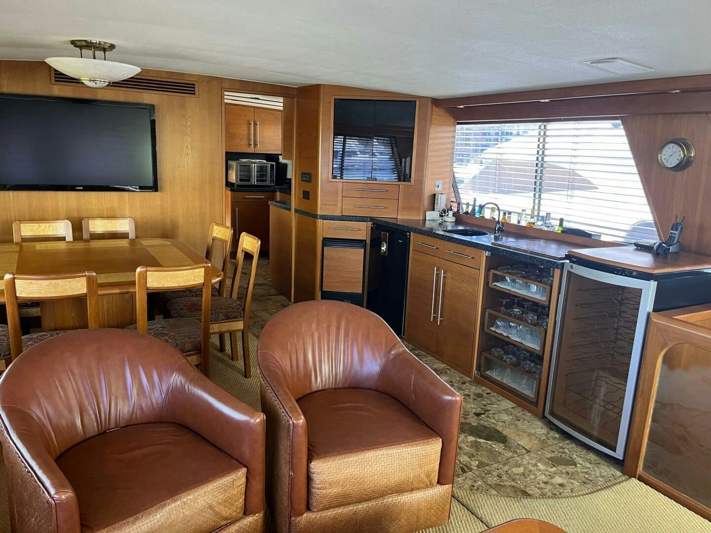 a living room with a kitchen and dining area aboard LADY T Yacht for Sale