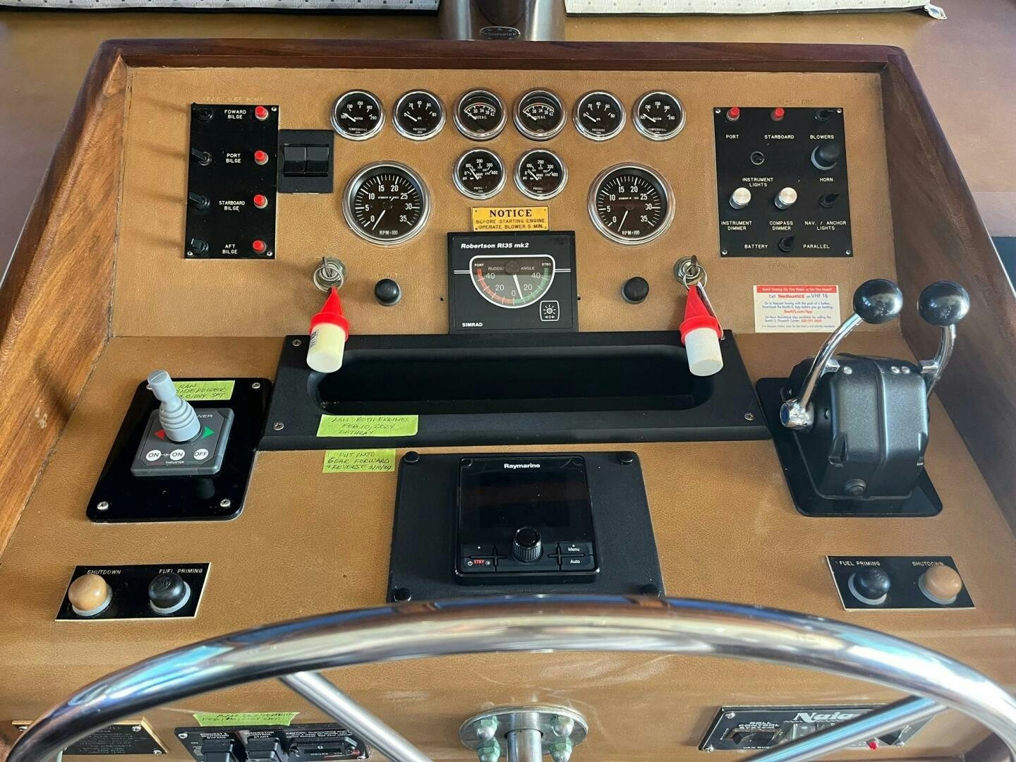 a wooden table with a variety of electronics on it aboard LADY T Yacht for Sale