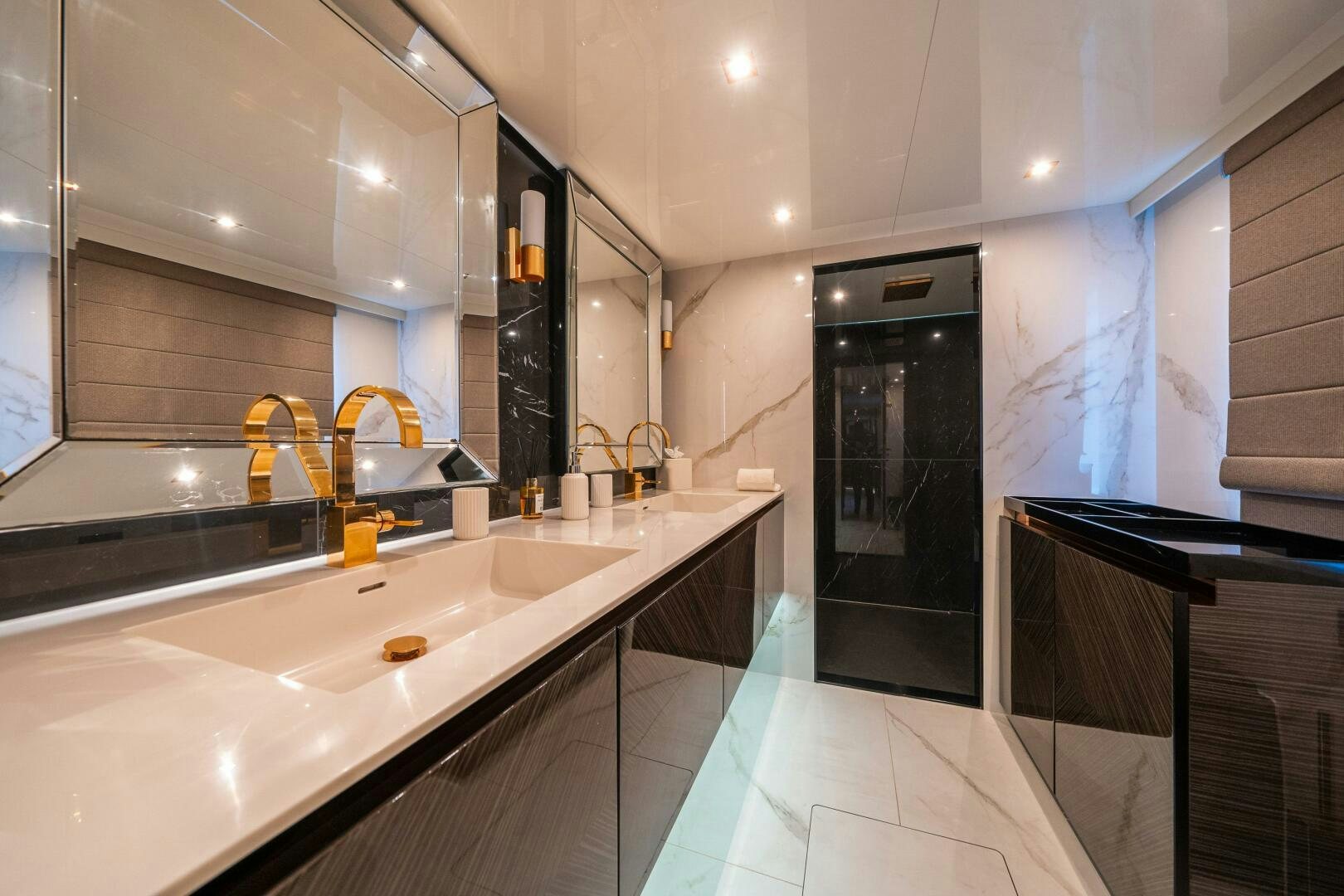 a modern bathroom with a large black countertop aboard SECOND CHANCE Yacht for Sale