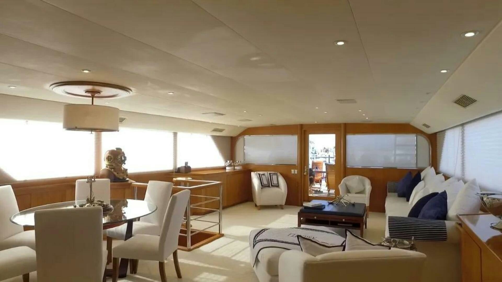 a room with a table chairs and a bed aboard THE BEST DAY Yacht for Sale