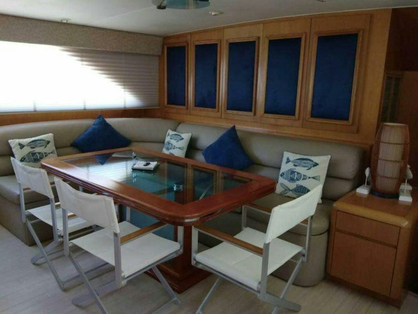 a living room with a table and chairs aboard THE BEST DAY Yacht for Sale