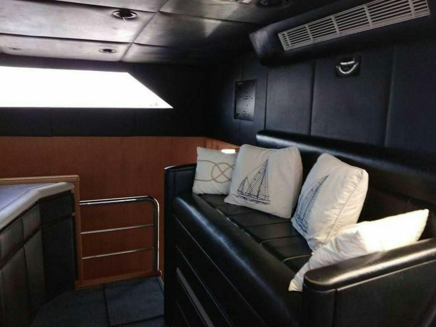 a room with a couch and a guitar aboard THE BEST DAY Yacht for Sale