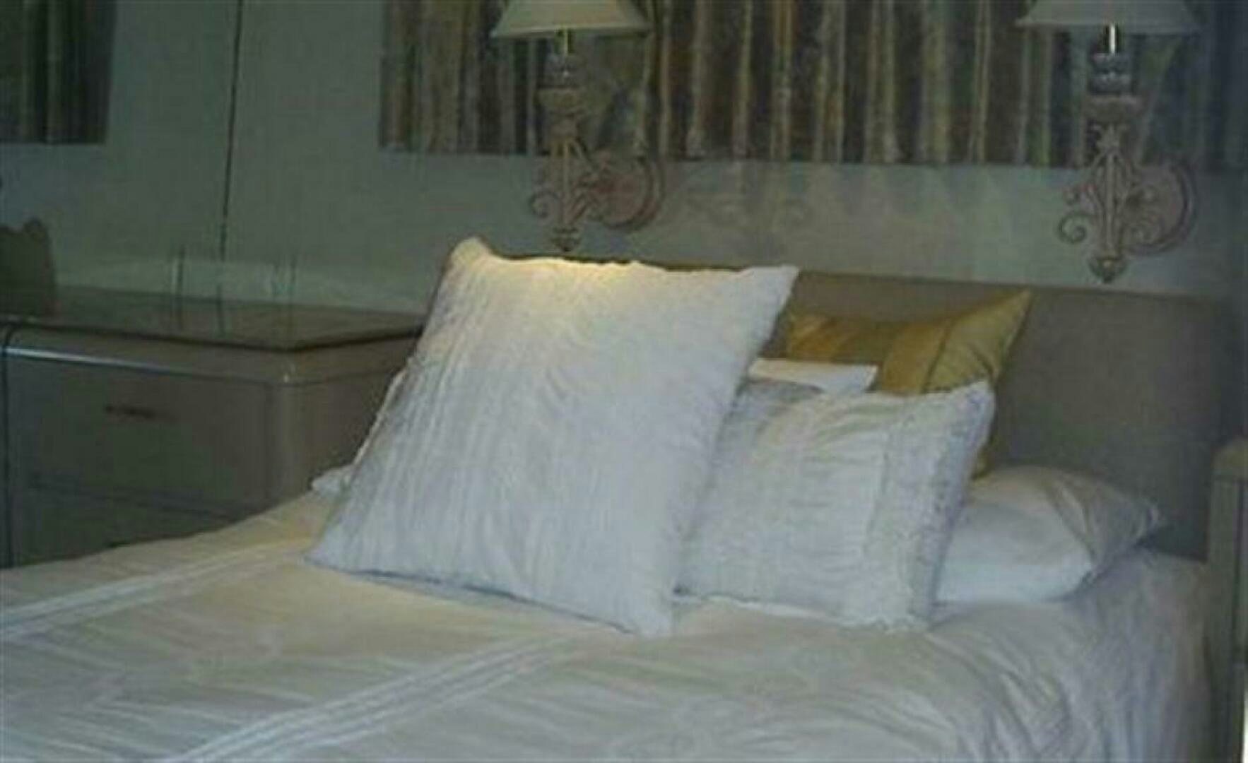a bed with white pillows aboard THE BEST DAY Yacht for Sale