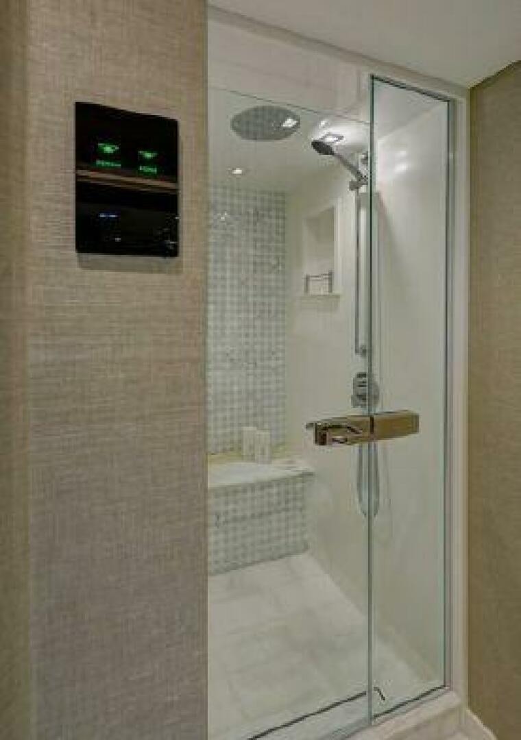 a bathroom with a glass shower aboard 75 HATTERAS M75 / 2020 Yacht for Sale