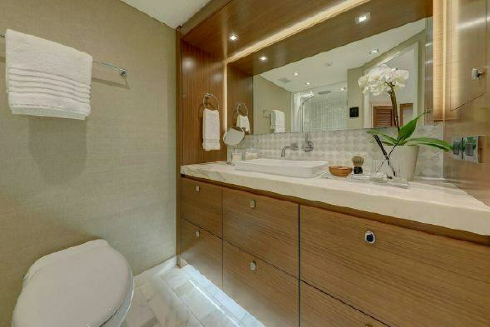 a bathroom with a large mirror aboard 75 HATTERAS M75 / 2020 Yacht for Sale