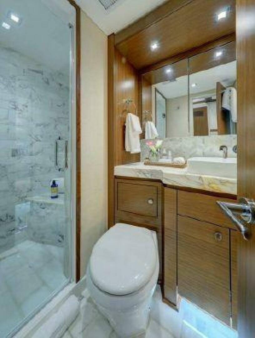 a bathroom with a toilet and a sink aboard 75 HATTERAS M75 / 2020 Yacht for Sale