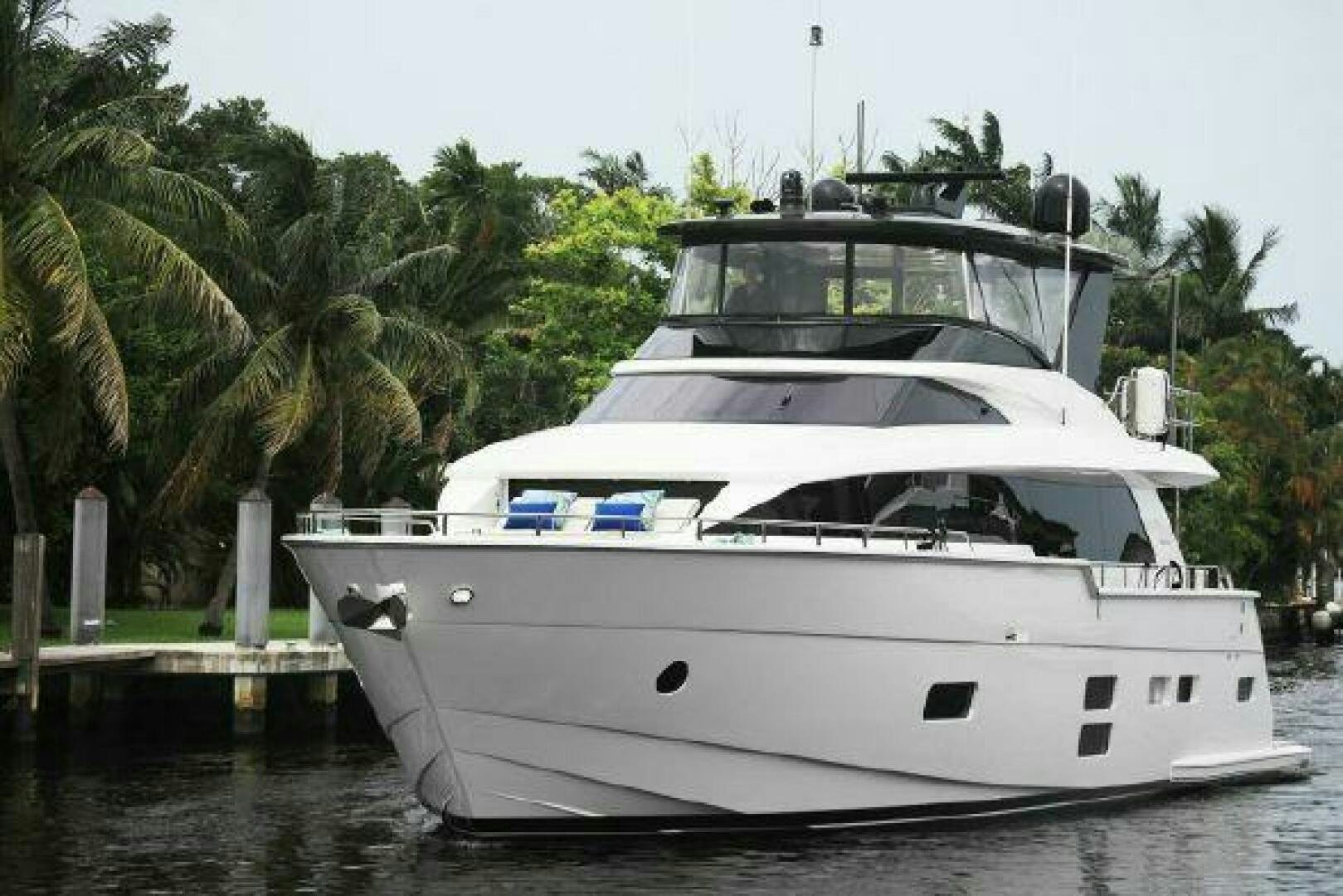a white yacht in a harbor aboard 75 HATTERAS M75 / 2020 Yacht for Sale